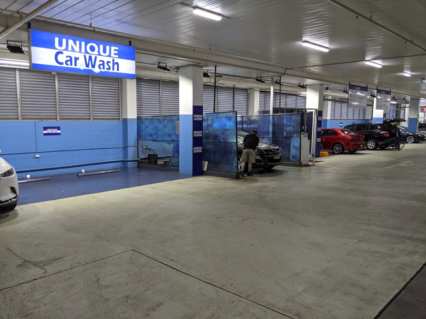 Inside UNIQUE Car Wash — spacious indoor facility with professional wash bays